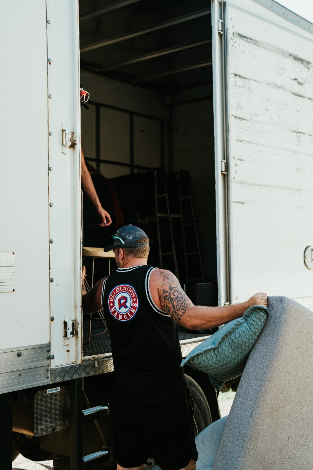 Brisbane removalists loading furniture into a Relocation Rangers moving truck